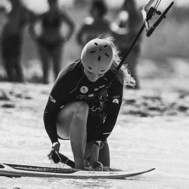 Katie Evans, professional wave kitesurfer from the United Kingdom, riding strapless in the surf